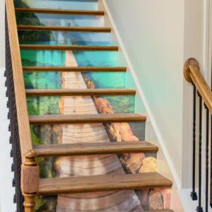 Contemporary hallway stairs with a glass riser design featuring a scenic wooden pier stretching into the ocean.